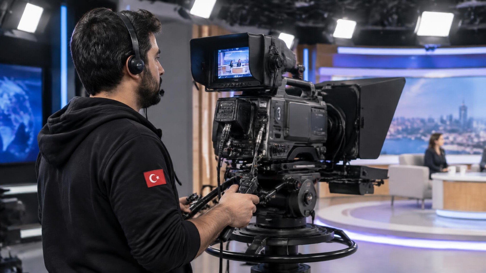 Camera operator filming a live television broadcast in a studio