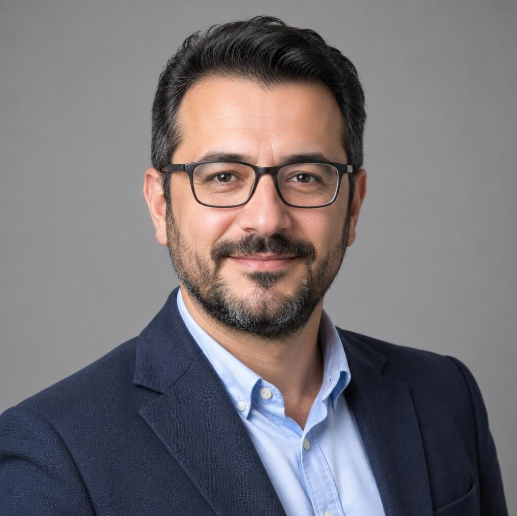 Studio portrait of a Turkish man wearing glasses, media trainer